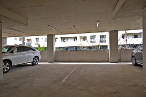 two cars parked in a parking lot with a building at Komitas Comfort and Charm in Yerevan