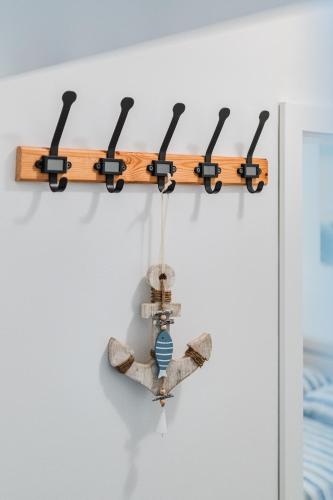 a shelf with aopus on a wall at Apartman Elephant in Postira