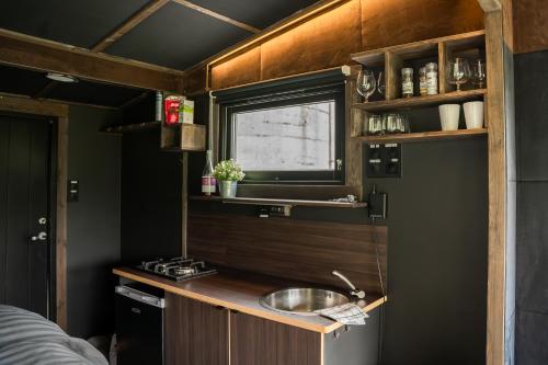 a kitchen with a sink in a tiny house at Panoramahytte med utsikt mot Eggenipa in Egge