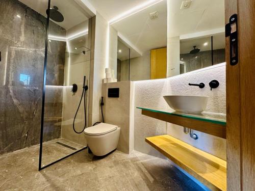 a bathroom with a shower and a toilet and a sink at Premium Stay - Opale Seaside Beachfront in Anfa-Supérieur