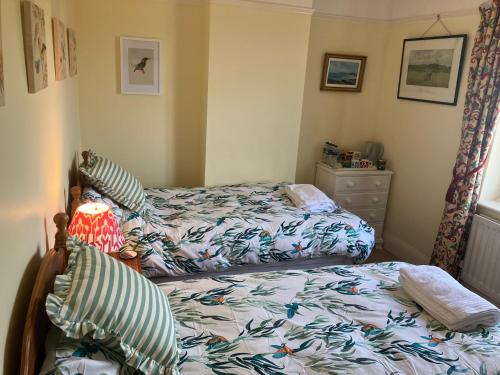 a bedroom with two beds and a dresser at Harcourt House, Charwelton in Charwelton