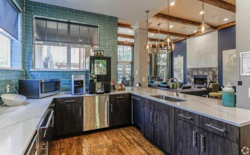 a large kitchen with a sink and a couch at Lavish Apartment near Houston Medical Centre in Houston