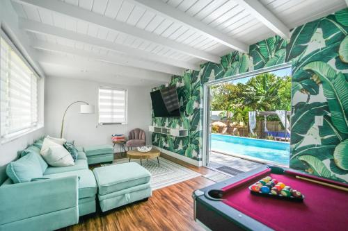 a living room with a couch and a pool table at La Playita 4-BR Heated Pool Miami 16 Guests in Miami
