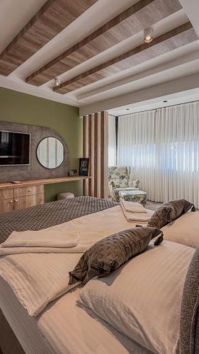 a hotel room with two beds and a chair at Leos Apartments Apart3 in Side