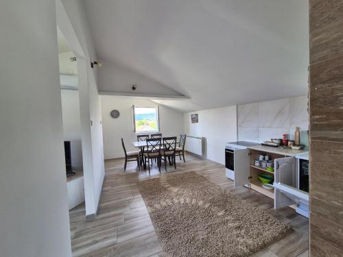 a kitchen and dining room with a table and chairs at Cozy, Fully Equipped, Free parking&Wifi, Quiet, 2BD in Podgorica