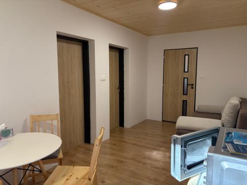 a living room with a table and a couch at Chata na lúke in Tatranska Strba