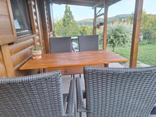 a wooden table and chairs on a patio at Jos 5 minuta in Jagodina