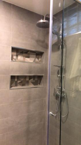 a bathroom with a shower with a glass door at Casa Hermosa Draria in Matriouene