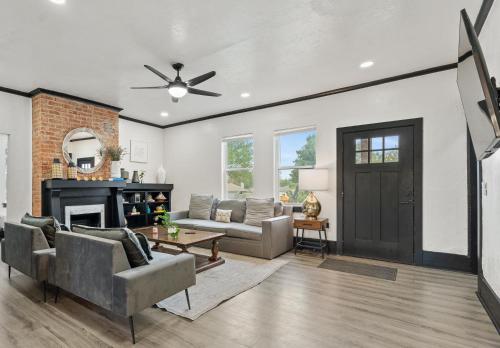 a living room with a couch and a fireplace at 6BR Home 10 mins Devon Park, Sleeps 16 #15 in Oklahoma City