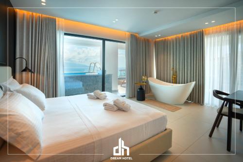 a bedroom with a tub and a bed and a bath room at DREAM HOTEL SARANDA in Sarandë