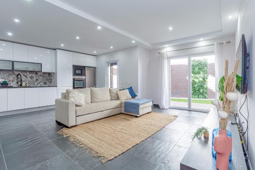 a living room with a couch and a kitchen at Charming Two-Bedroom Apartment in Zambujeira do Mar by Golden Zenith in Zambujeira do Mar