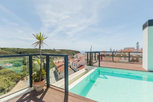 a balcony with a swimming pool on top of a building at Charming Two-Bedroom Apartment in Zambujeira do Mar by Golden Zenith in Zambujeira do Mar