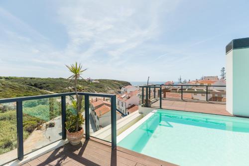 a swimming pool on the balcony of a house at Charming Two-Bedroom Apartment in Zambujeira do Mar by Golden Zenith in Zambujeira do Mar