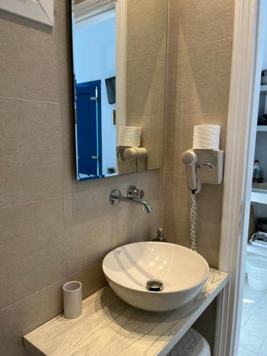 a bathroom with a white sink and a mirror at Captain Stavros in Pollonia