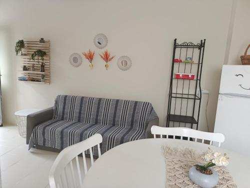 a living room with a couch and a table at Cavo Prima Kiotari in Gennadi
