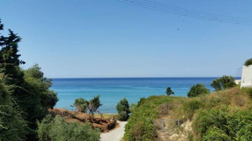 a beach with the ocean in the background at Anemone Blue Seaside Apartments in Zakynthos Town