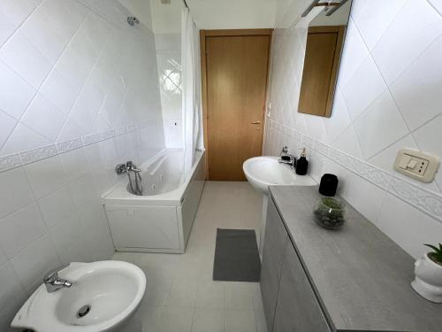 a white bathroom with a sink and a toilet at ConeroAir, A place to come back to in Porto Recanati