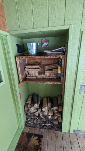a cupboard filled with lots of fire wood at Le refuge de la petite rivière in Saint Mathieu Du Parc