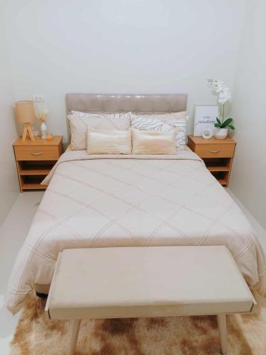 a bedroom with a large white bed with two night stands at Langga Crib in Lapu Lapu City