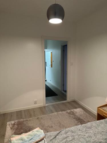 a white room with a mirror and a hallway at Kivimiehenkatu 4 in Kouvola