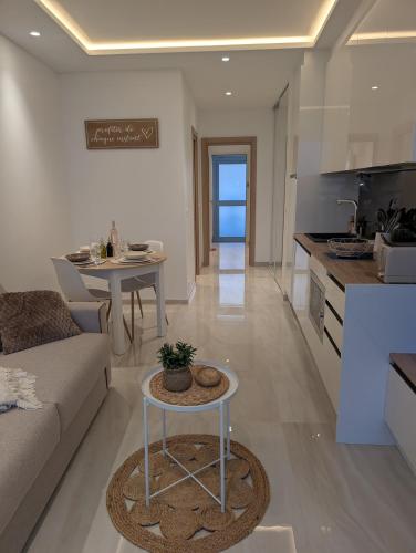 une cuisine et un salon avec un canapé et une table dans l'établissement Marina Baie des Anges, Sublime Studio rénové, à Villeneuve-Loubet