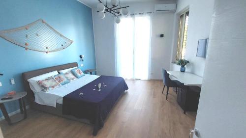 a bedroom with a bed and a table and a desk at La Terrazza Del Sole di Mondello in Palermo