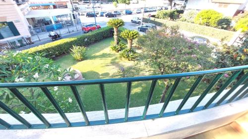 a balcony with a view of a street with cars at La Terrazza Del Sole di Mondello in Palermo