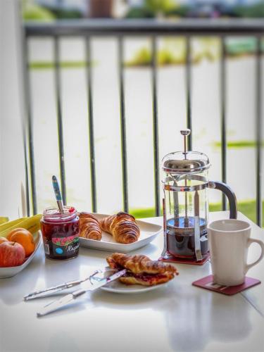 a table with plates of food and a cup of coffee at Park View in Banbury
