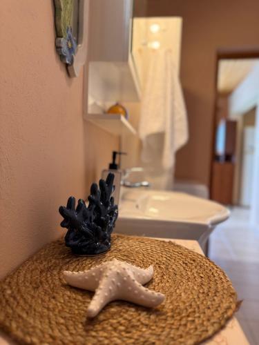 a bathroom with a starfish and a sink at Sotirias Beach House in Kalamos