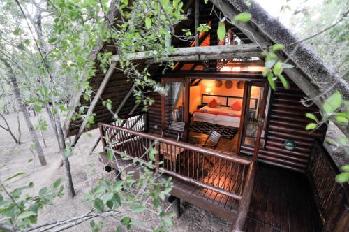 a bedroom in a tree house in the woods at Hluhluwe River Lodge in Hluhluwe