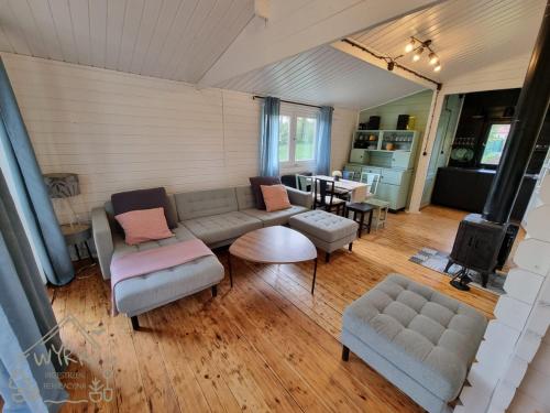 a living room with a couch and chairs and a table at Wyrki - Przestrzeń Rekreacyjna in Ćmińsk