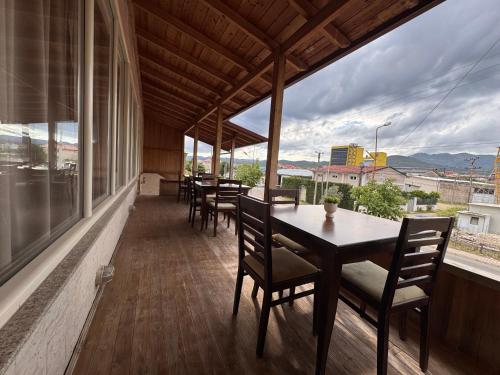 a table and chairs on a balcony with a view at Vila Diora Hostel in Elbasan