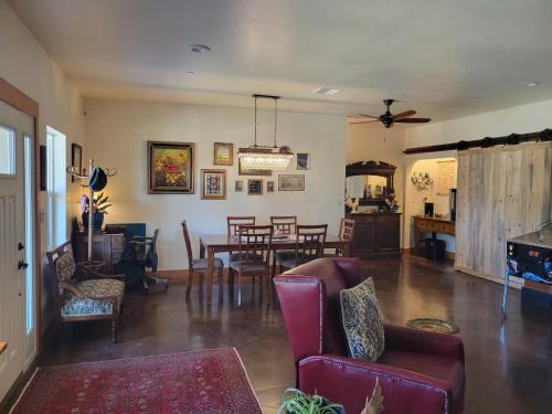a living room with a table and chairs and a dining room at 8 Mile Farm Bed & Breakfast in The Dalles