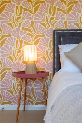a lamp on a table next to a bed at 30 Cozy and stylish private Studio Apartment in Bourne End
