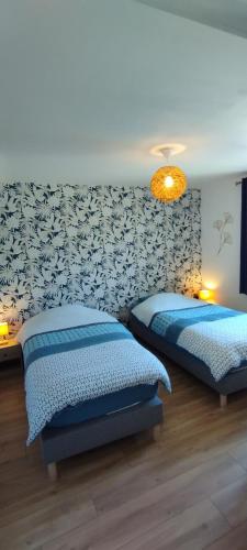 une chambre avec deux lits et un mur dans l'établissement Charmante maison de campagne, avec jardin, vue rivière, 15 min Cabourg, à Basseneville