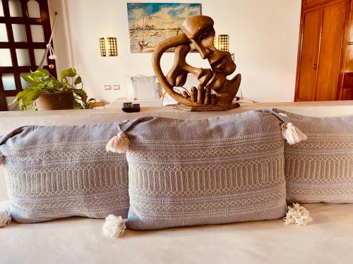 a statue of a girl sitting on top of a pillow at Hotel Para Ti - Adults Only in Holbox Island