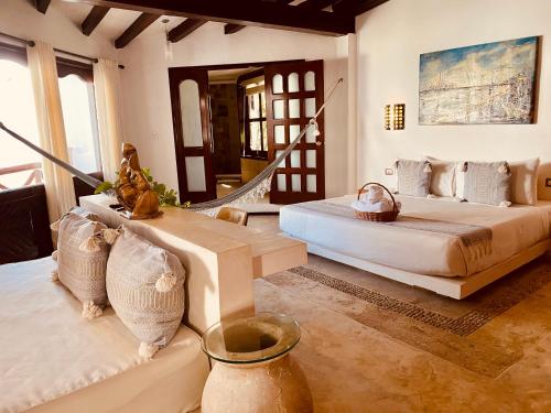 a bedroom with two beds and a staircase at Hotel Para Ti - Adults Only in Holbox Island
