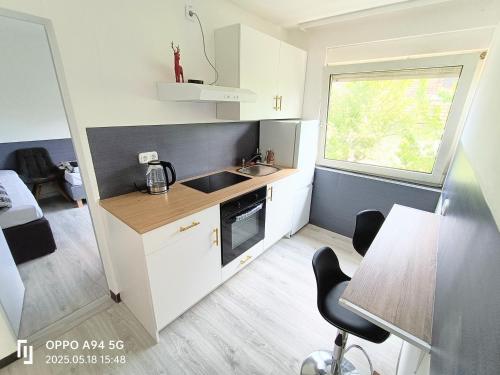 a small kitchen with a sink and a table at FMi21 in Hochheim am Main