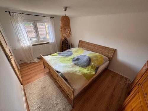 a bedroom with a bed with yellow and blue pillows at Ferienwohnung Odenwald Fernblick in Brombachtal