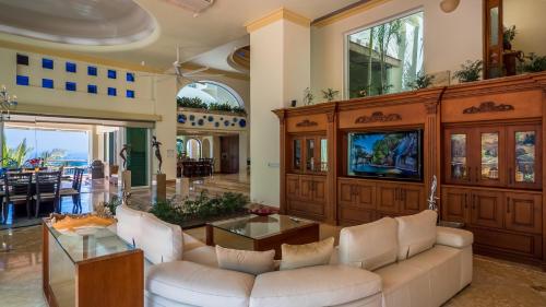 a living room with a couch and a tv at P V near Colomitos Beach Boutique Hotel in Puerto Vallarta