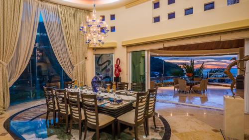 a dining room with a table with chairs and a chandelier at P V near Colomitos Beach Boutique Hotel in Puerto Vallarta