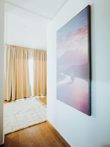 a large painting on a wall next to a window at Medina Hotel Dakhla in Dakhla