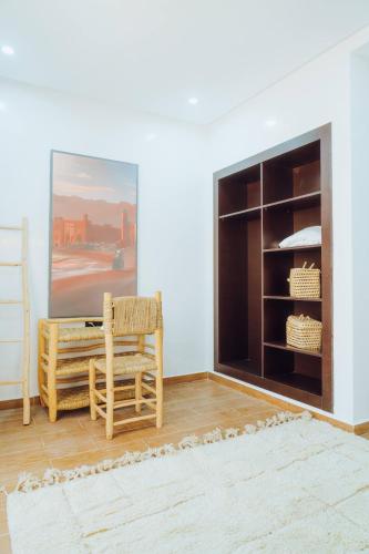 a living room with a chair and a fireplace at Medina Hotel Dakhla in Dakhla
