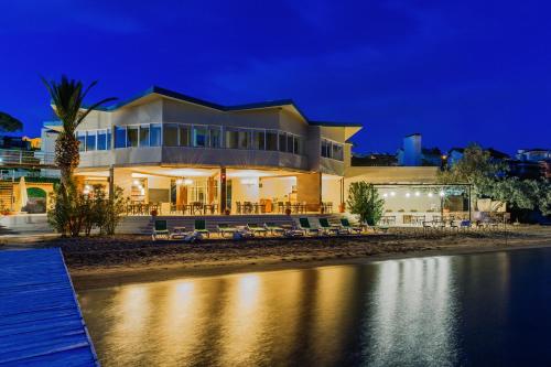 a house on the beach at night at Cunda Hotel in Ayvalık
