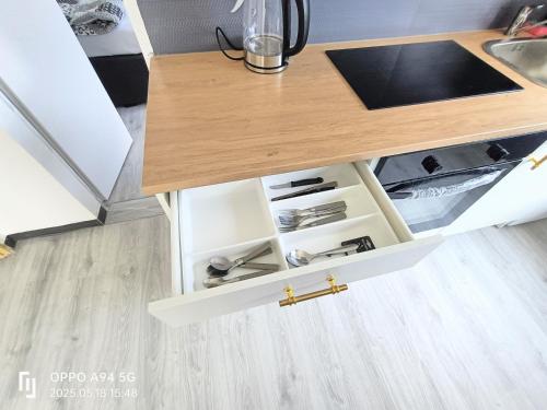 a kitchen cabinet with white drawers and a wooden table at FMi21 in Hochheim am Main