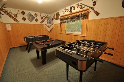 two ping pong tables are in a room with wooden walls at Pokoje Gościnne Janina in Zakopane