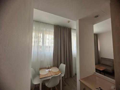 a room with a table and chairs and a window at bookVienna "Paula" Apartments in Vienna