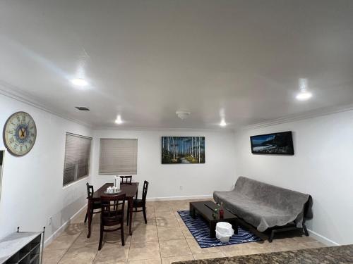 a living room with a couch and a table at Near Disney,college,sunset beach ,airport in Norwalk
