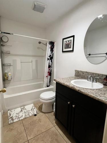 a bathroom with a tub and a sink and a toilet at Near Disney,college,sunset beach ,airport in Norwalk