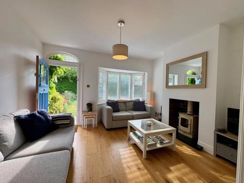 a living room with a couch and a table at Eden Cottage in Frodsham